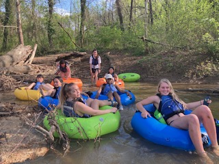 Outdoor equipment rental students in floating tubes