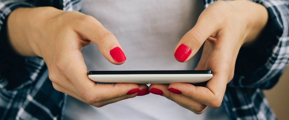 Hands holding typing on a cell phone