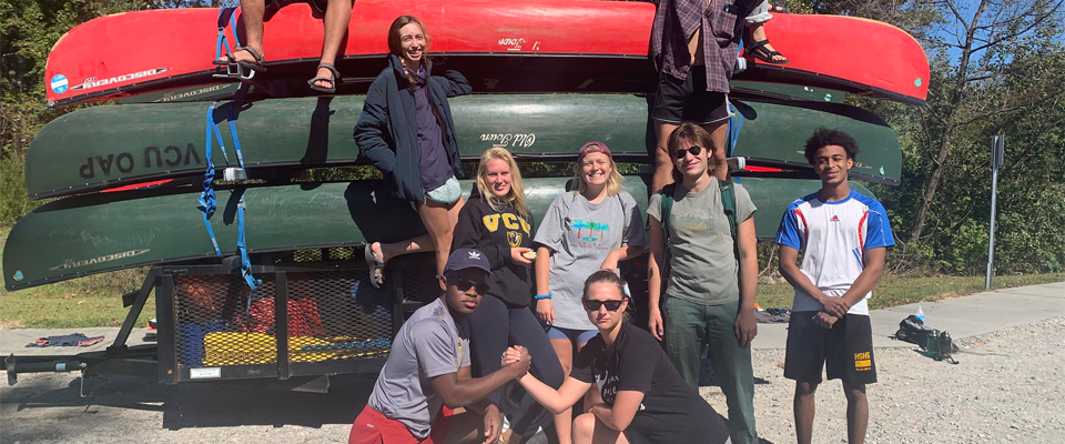 OAP participants posing in front of a canoe trailer