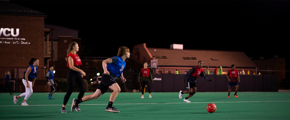 Students play Intramural Soccer on the Cary Street Field at night